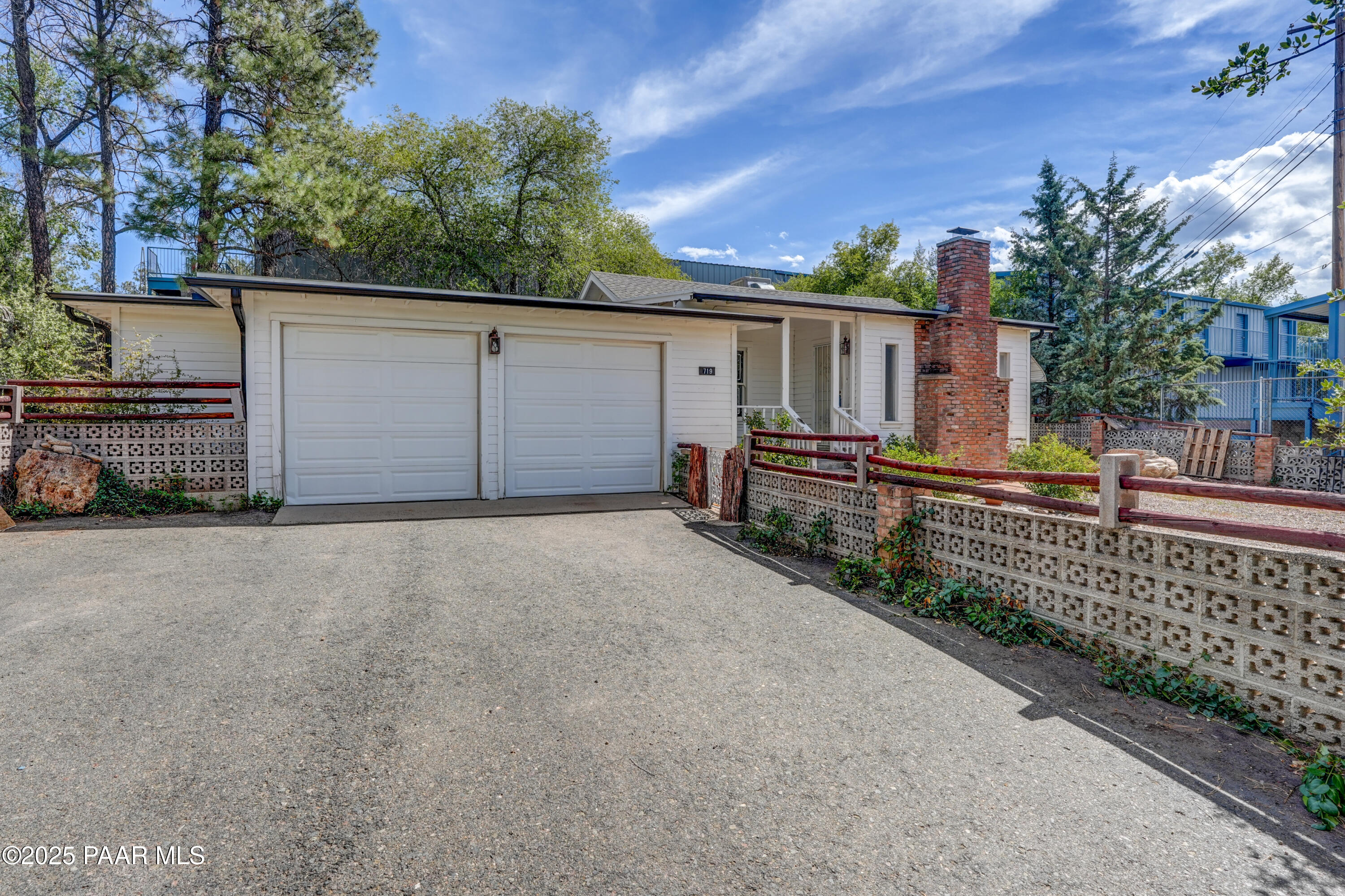 a view of a house with a wooden fence