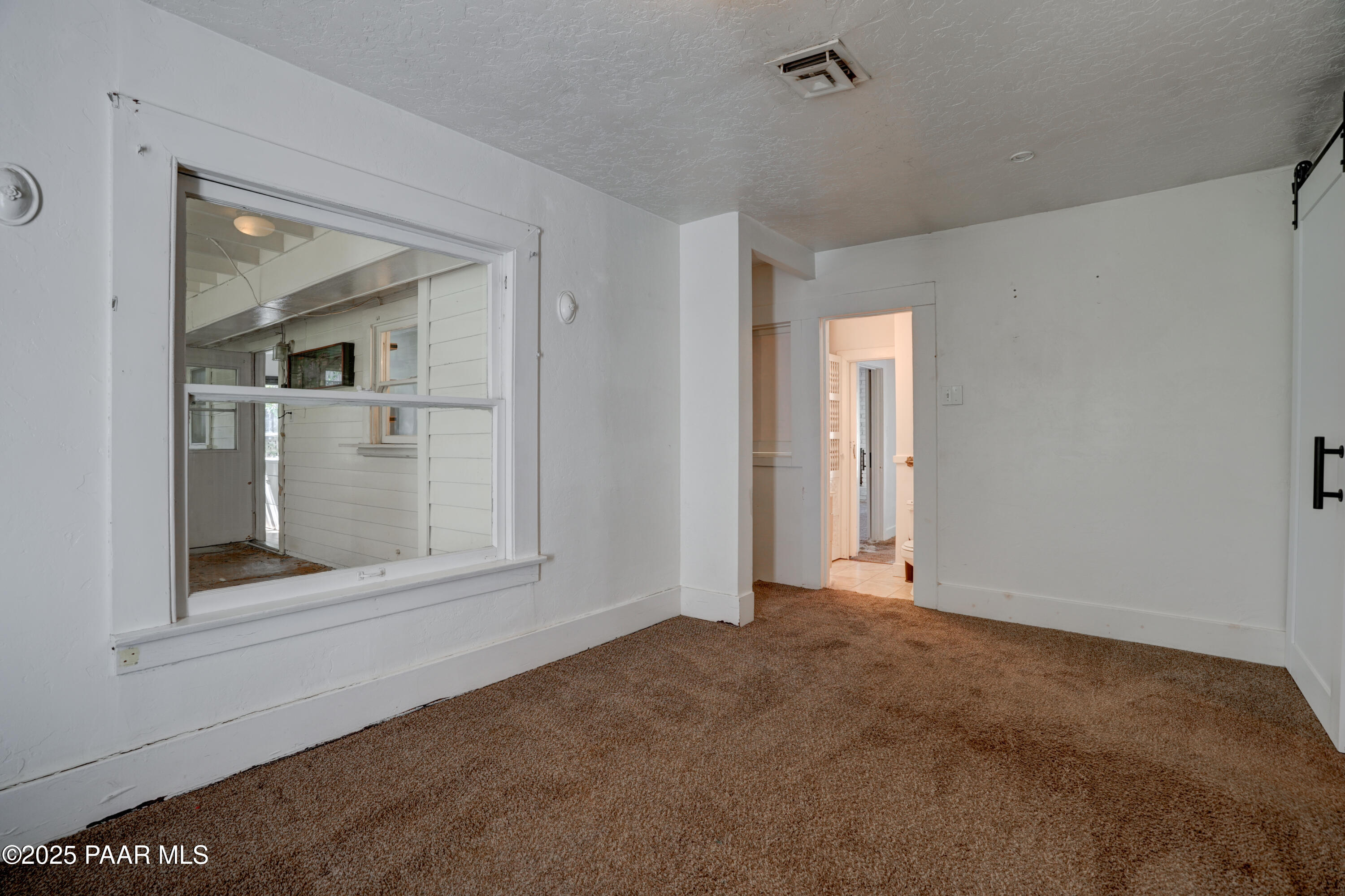 719 Pima Road Prescott, AZ 86303 - Photo 17 of 31 a view of an empty room with closet and a window