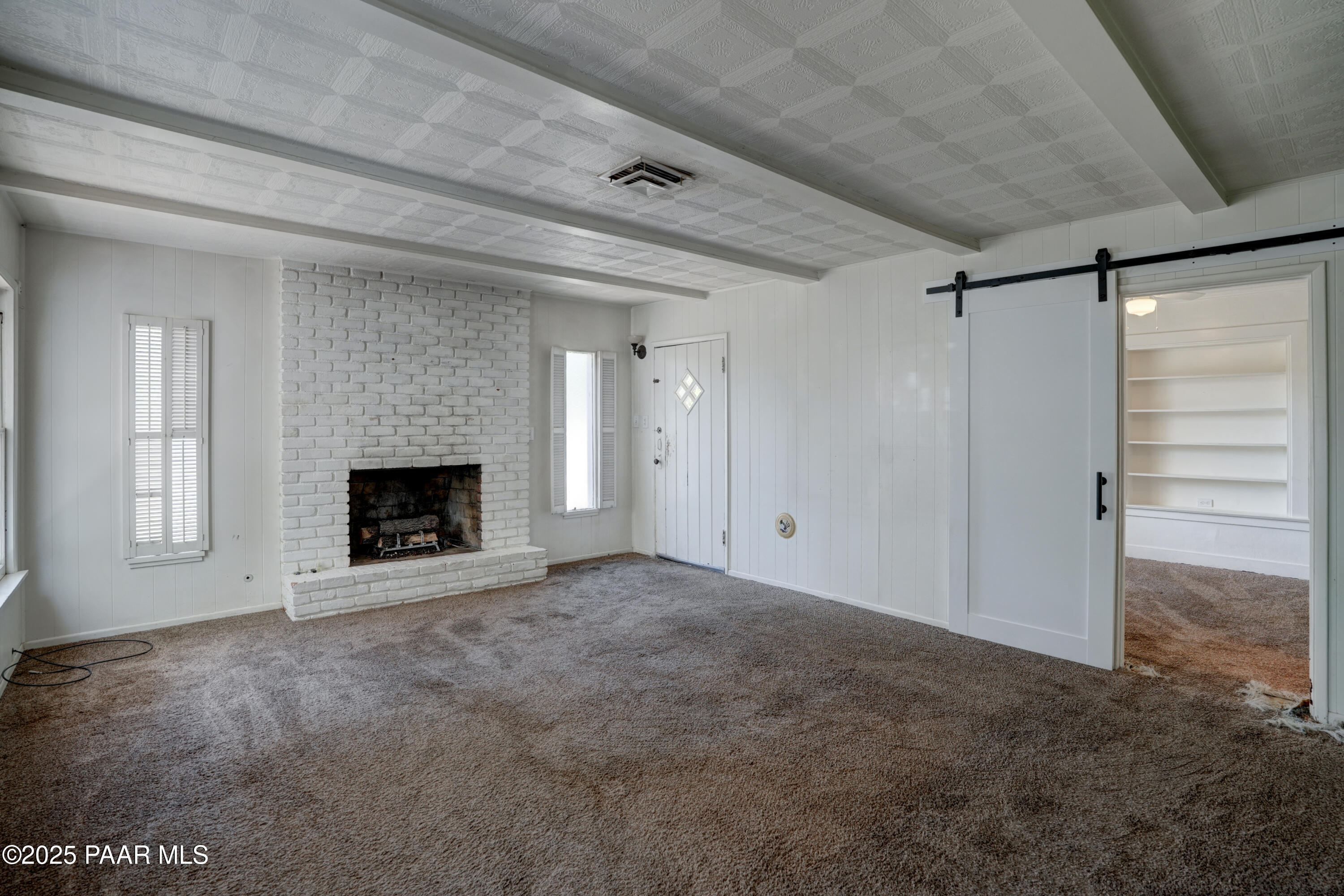 719 Pima Road Prescott, AZ 86303 - Photo 24 of 31 a view of an empty room with a fireplace and a window