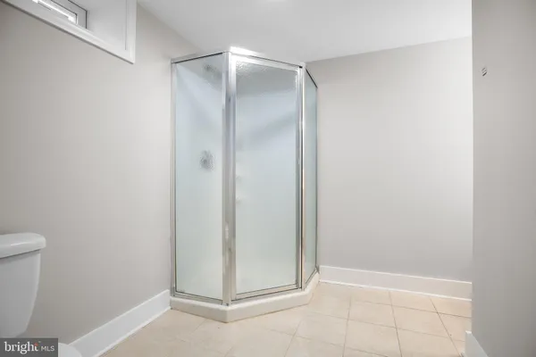 a bathroom with a glass door shower