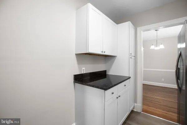 a view of kitchen with white cabinets
