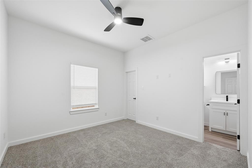 1311 Oneal Street, Unit B Commerce, TX 75428 - Photo 12 of 17 an empty room with windows and cabinet