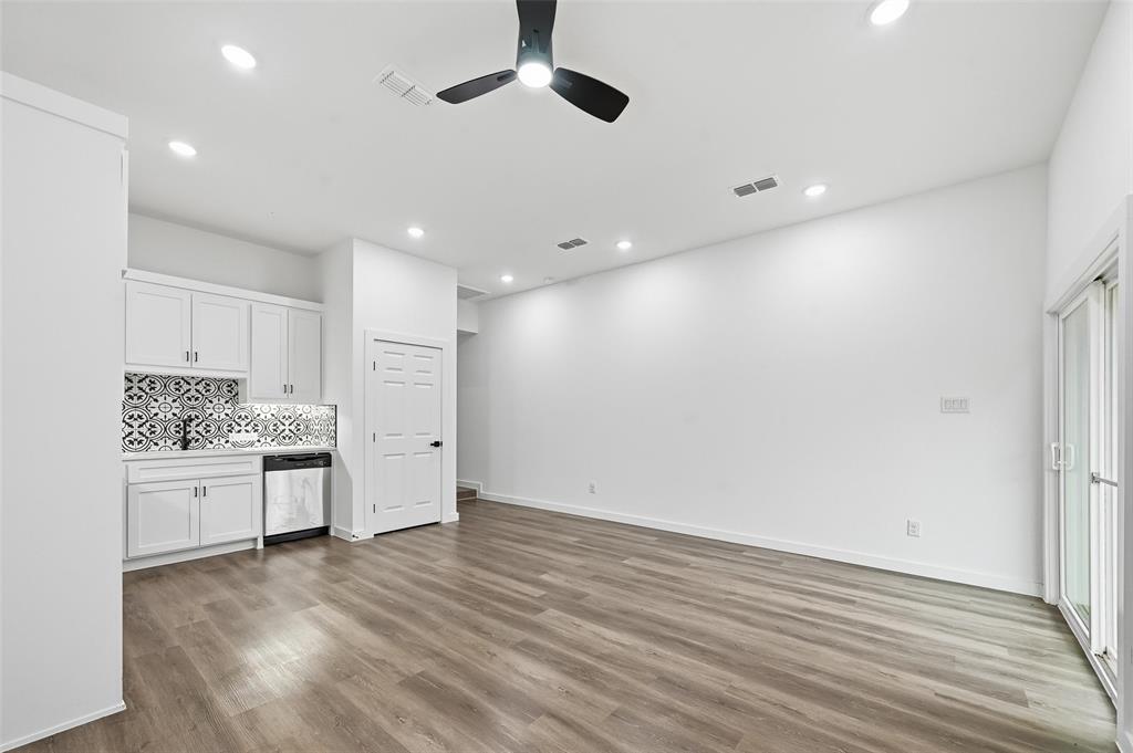 1311 Oneal Street, Unit B Commerce, TX 75428 - Photo 4 of 17 an empty room with wooden floor cabinet and windows