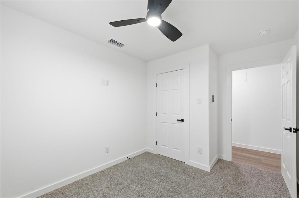 1311 Oneal Street, Unit B Commerce, TX 75428 - Photo 9 of 17 an empty room with chandelier fan