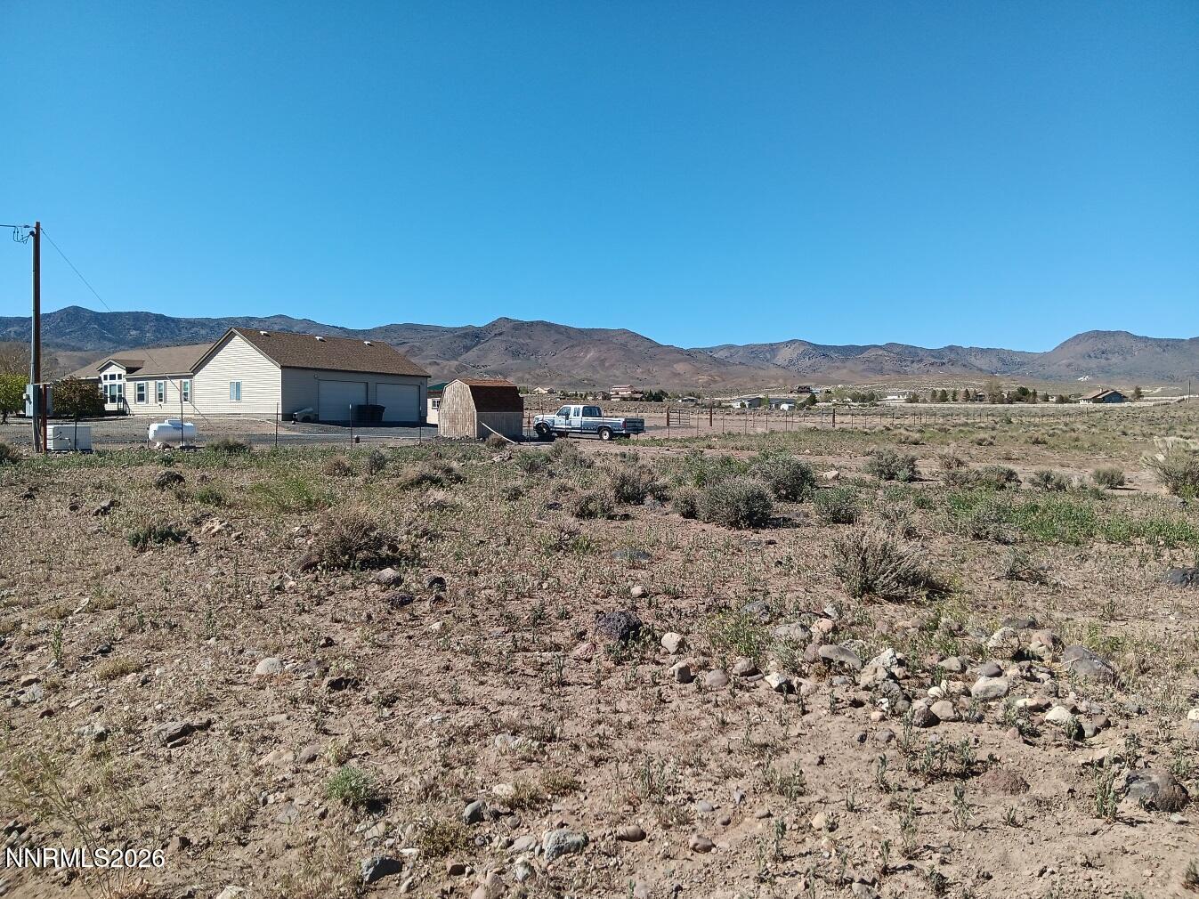 12460 Seneca Road Stagecoach, NV 89429 - Photo 5 of 6 a view of a dry yard with wooden fence