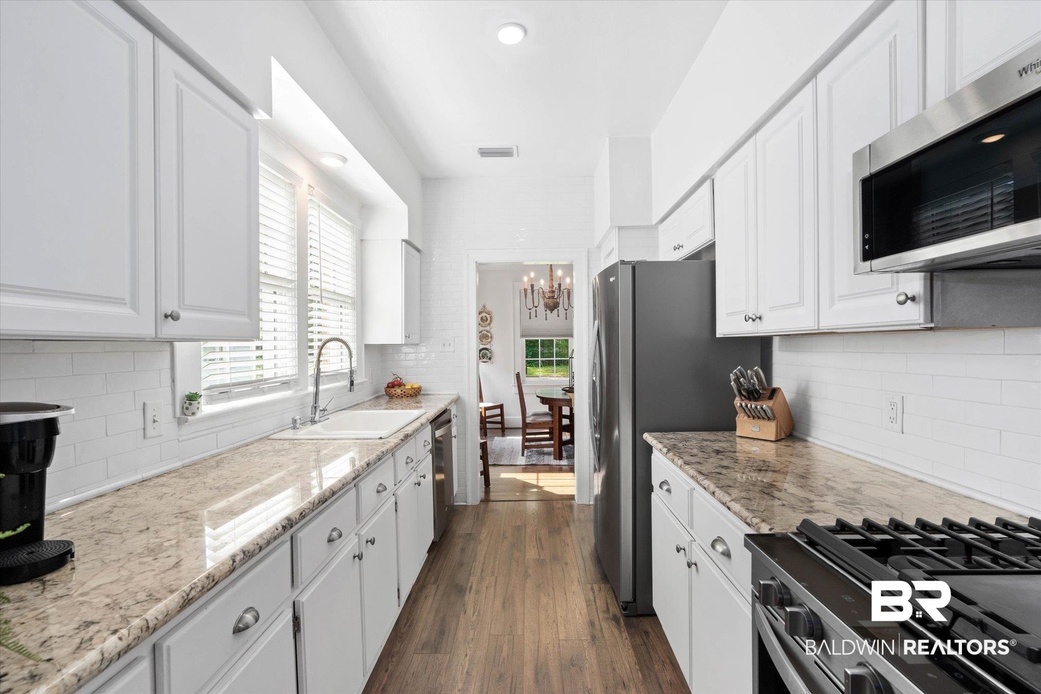 1910 Hunter Avenue Mobile, AL 36606 - Photo 9 of 21 Kitchen featuring stainless steel appliances, a sink, a chandelier, and backsplash