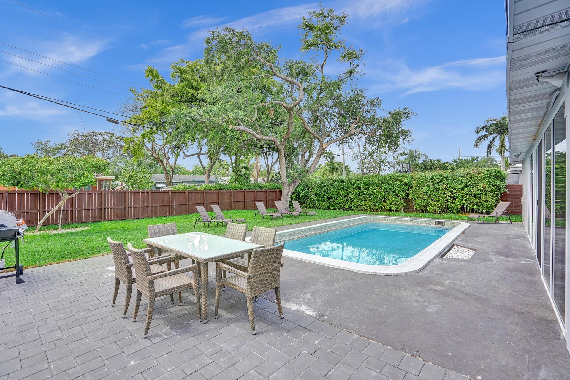 2114 North 42nd Avenue Hollywood, FL 33021 - Photo 21 of 24 a view of a chairs and table in backyard