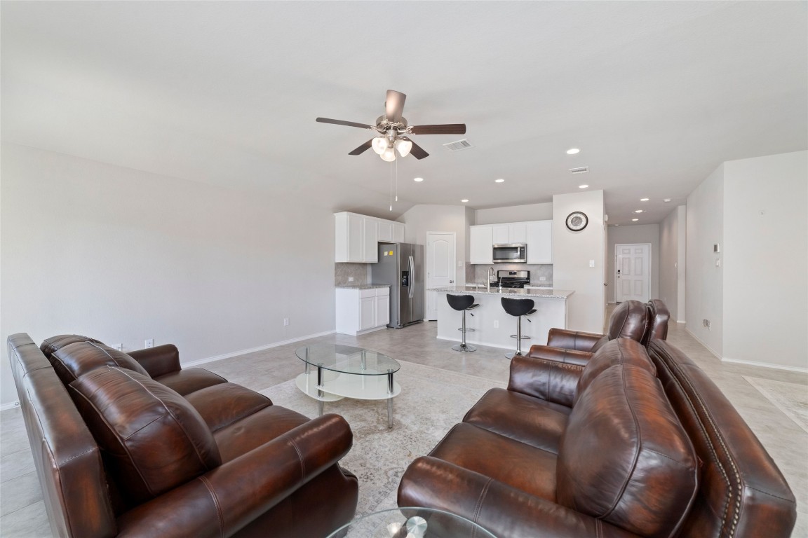 24323 Winchelsea Lane Spring, TX 77389 - Photo 13 of 27 a living room with furniture kitchen view and a chandelier