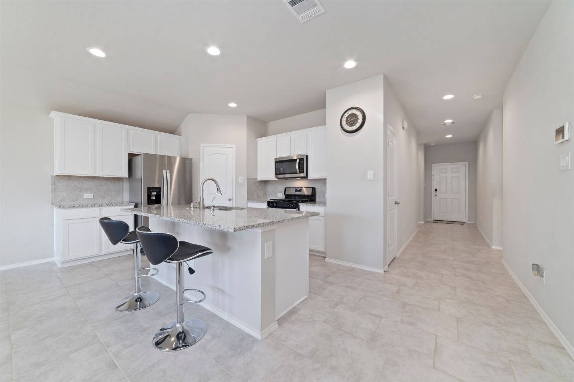 24323 Winchelsea Lane Spring, TX 77389 - Photo 15 of 27 a kitchen with kitchen island granite countertop appliances cabinets and a sink