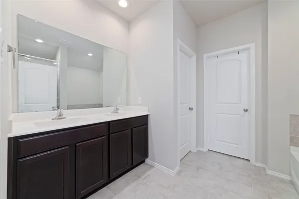a bathroom with a double vanity sink and mirror