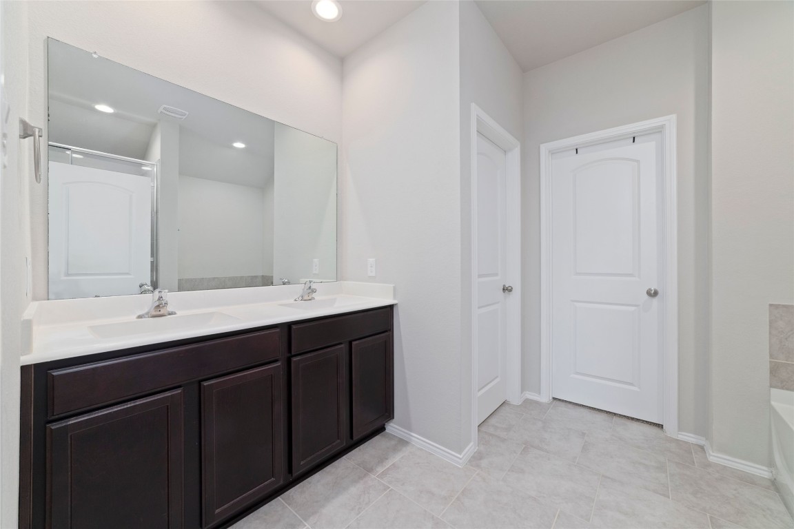 24323 Winchelsea Lane Spring, TX 77389 - Photo 21 of 27 a bathroom with a double vanity sink and mirror
