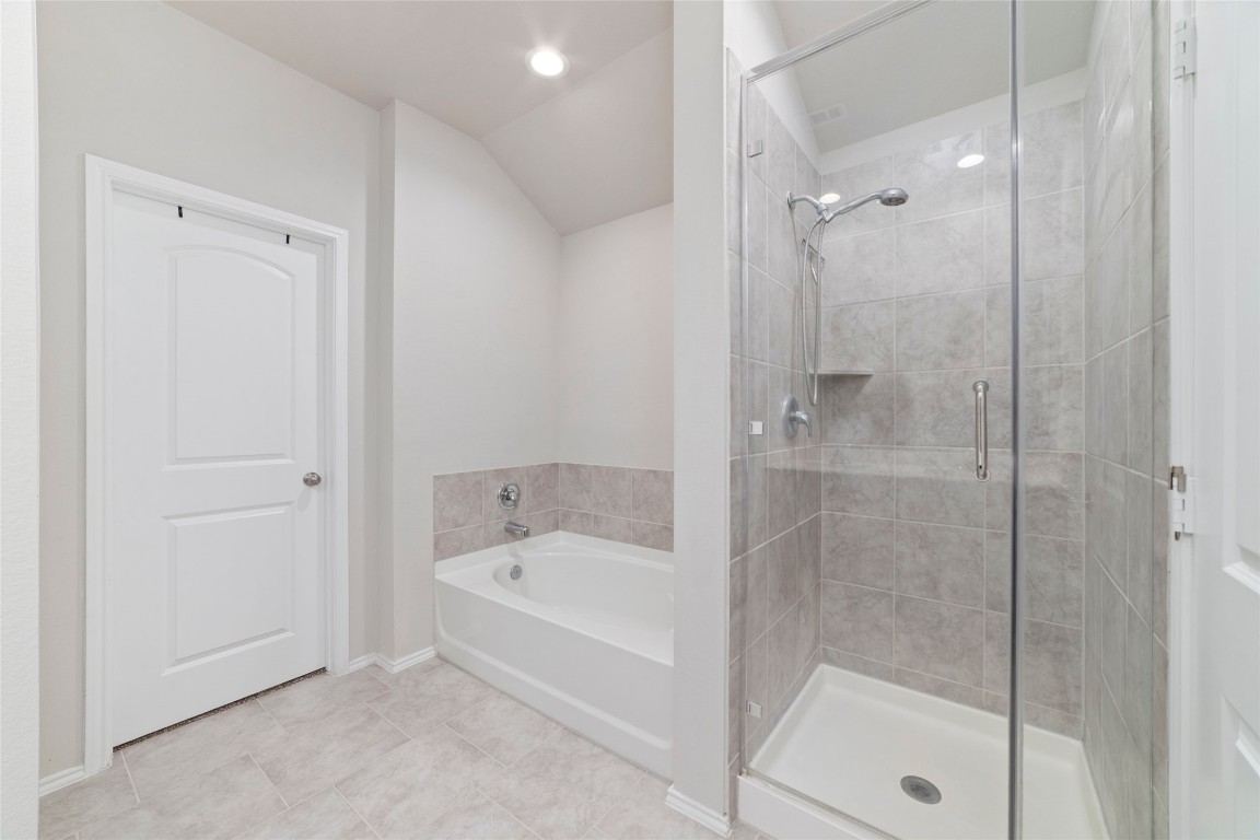 24323 Winchelsea Lane Spring, TX 77389 - Photo 22 of 27 a bathroom with a bathtub and a shower