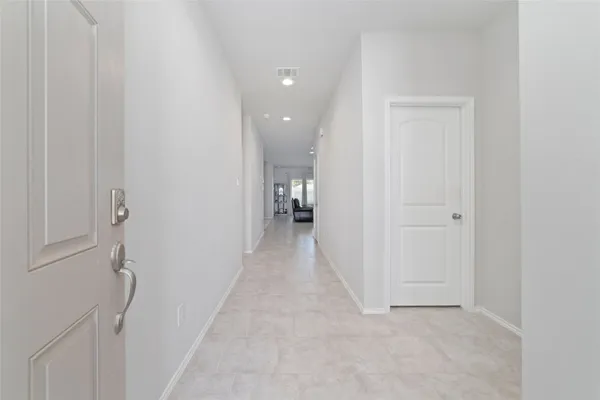a view of a hallway with wooden shelves