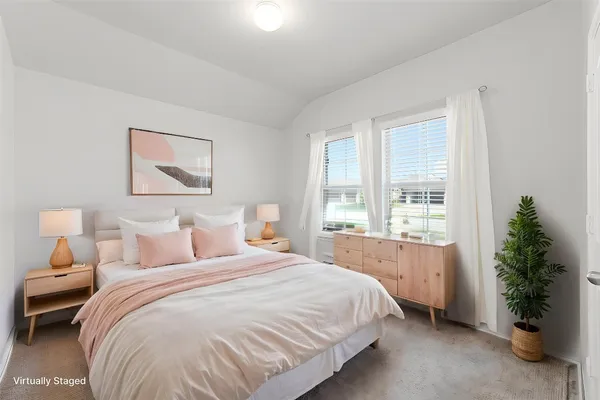 a bedroom with a bed and a potted plant