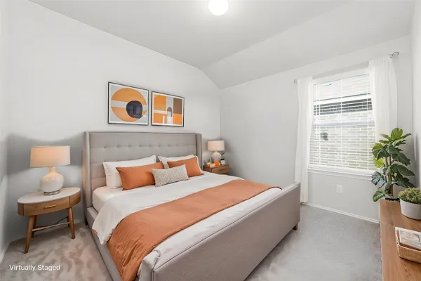 a bedroom with a bed and potted plant