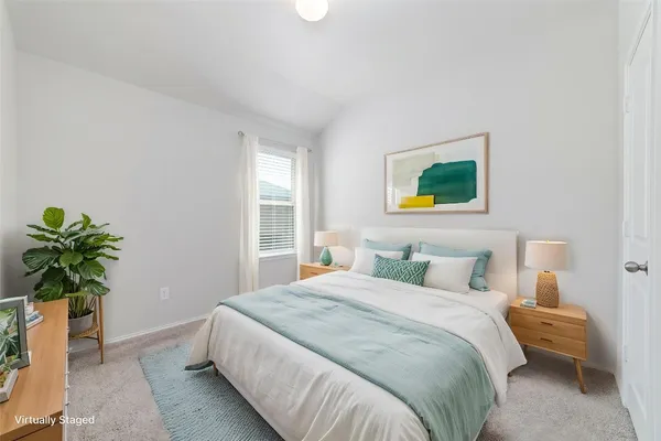a bedroom with a bed and a potted plant