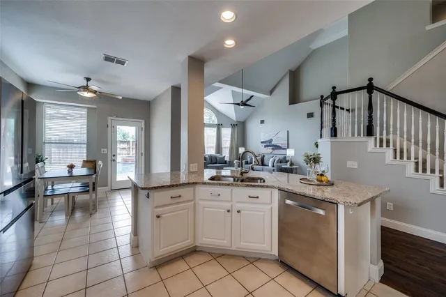 a kitchen with sink cabinets and stove