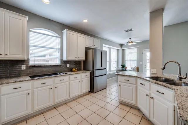 a kitchen with sink and white cabinets
