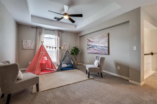 a room with furniture and a ceiling fan