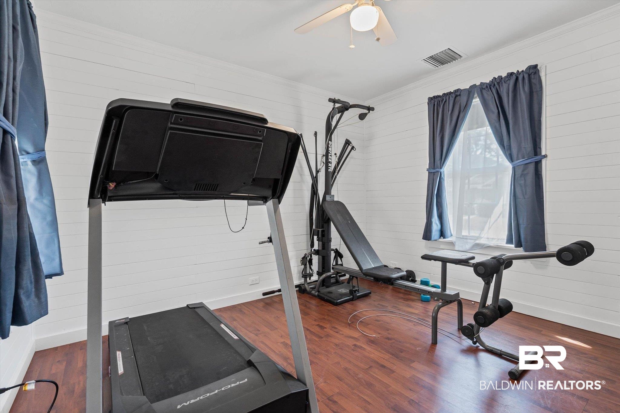 6175 South Grand Bay Wilmer Road Grand Bay, AL 36541 - Photo 24 of 42 Workout room featuring dark wood-style floors, wooden walls, and crown molding