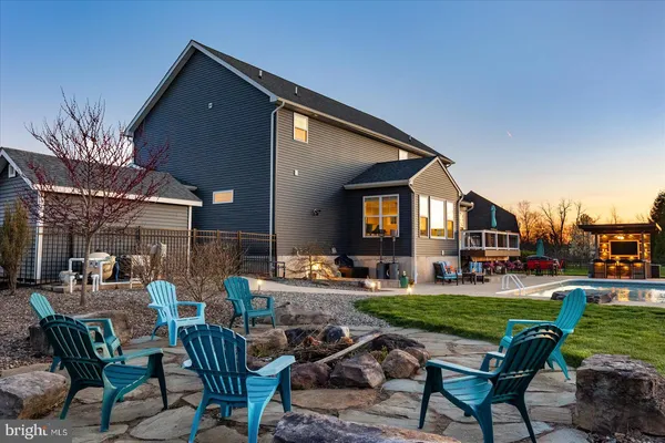 a view of an house with backyard and furniture