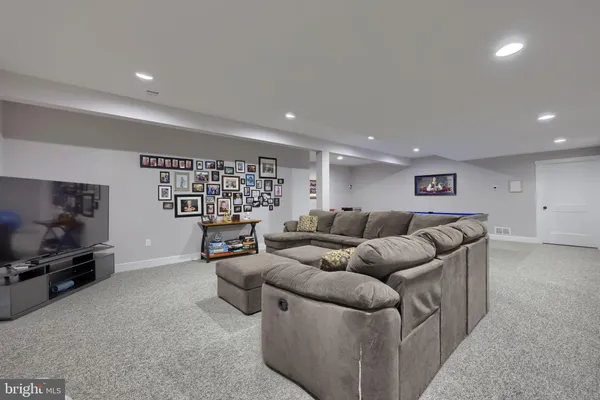 a room with furniture pool table and windows