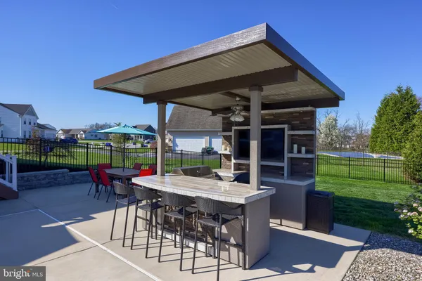a view of a patio with a table and chairs
