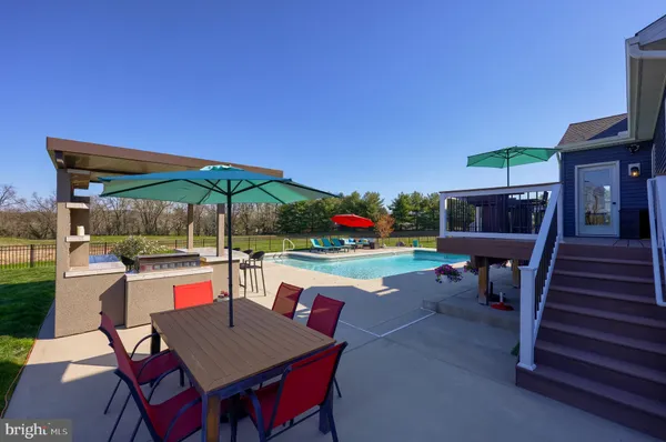 a view of a chairs and table in the balcony