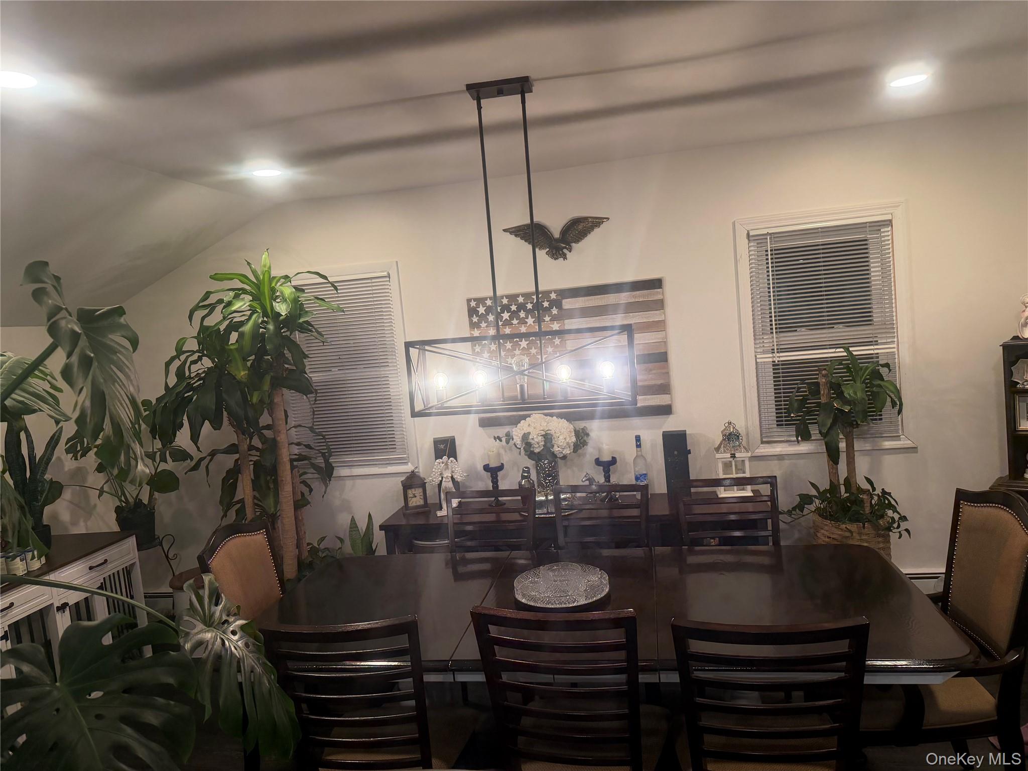 1580 North Jerusalem Road Merrick, NY 11566 - Photo 16 of 36 Dining area featuring a dark wood table with matching chairs, an elegant chandelier, and recessed lighting