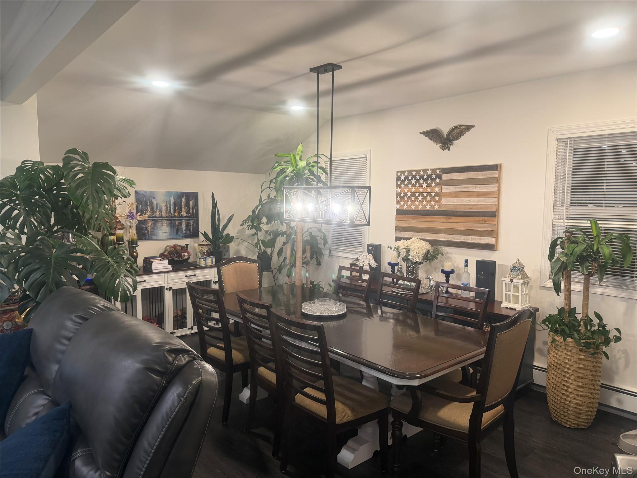 1580 North Jerusalem Road Merrick, NY 11566 - Photo 17 of 36 The dining area features wood flooring, a rectangular dining table with seating, and overhead lighting