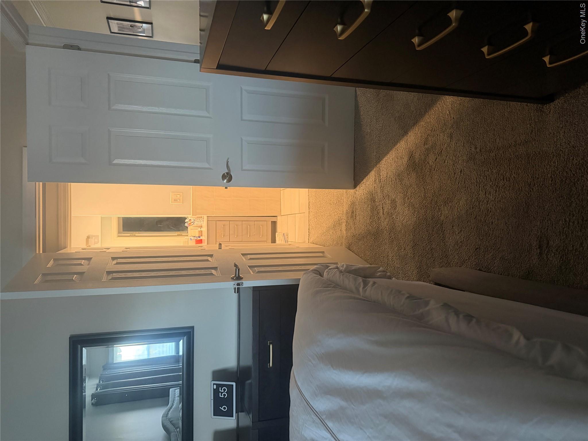 1580 North Jerusalem Road Merrick, NY 11566 - Photo 20 of 36 Bedroom featuring carpeted flooring and a doorway leading to a bathroom with a vanity and mirror