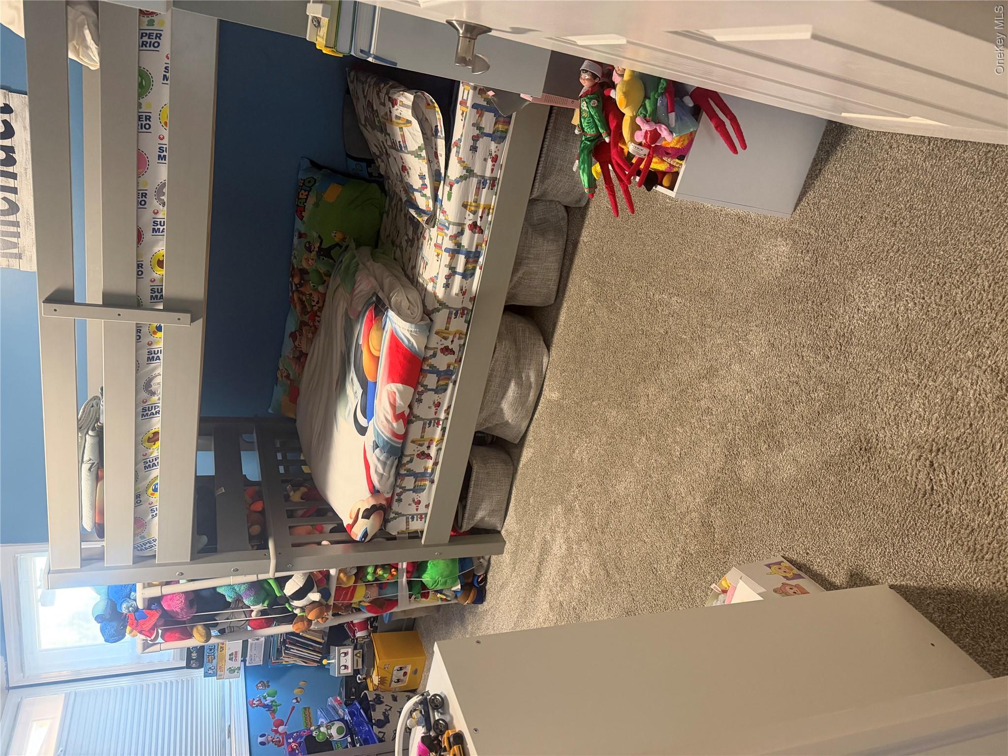 1580 North Jerusalem Road Merrick, NY 11566 - Photo 21 of 36 This room features a bunk bed with a grey frame, a light-colored carpet, and a window with horizontal blinds