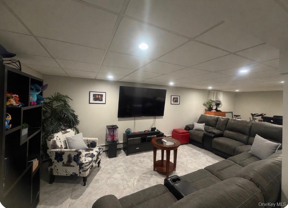1580 North Jerusalem Road Merrick, NY 11566 - Photo 26 of 36 Expansive living area featuring light-colored walls, recessed lighting, and a drop ceiling
