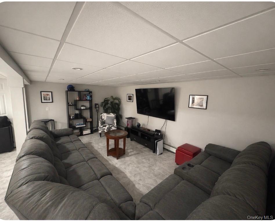 1580 North Jerusalem Road Merrick, NY 11566 - Photo 27 of 36 Living area featuring light-colored walls, recessed lighting, and a drop ceiling