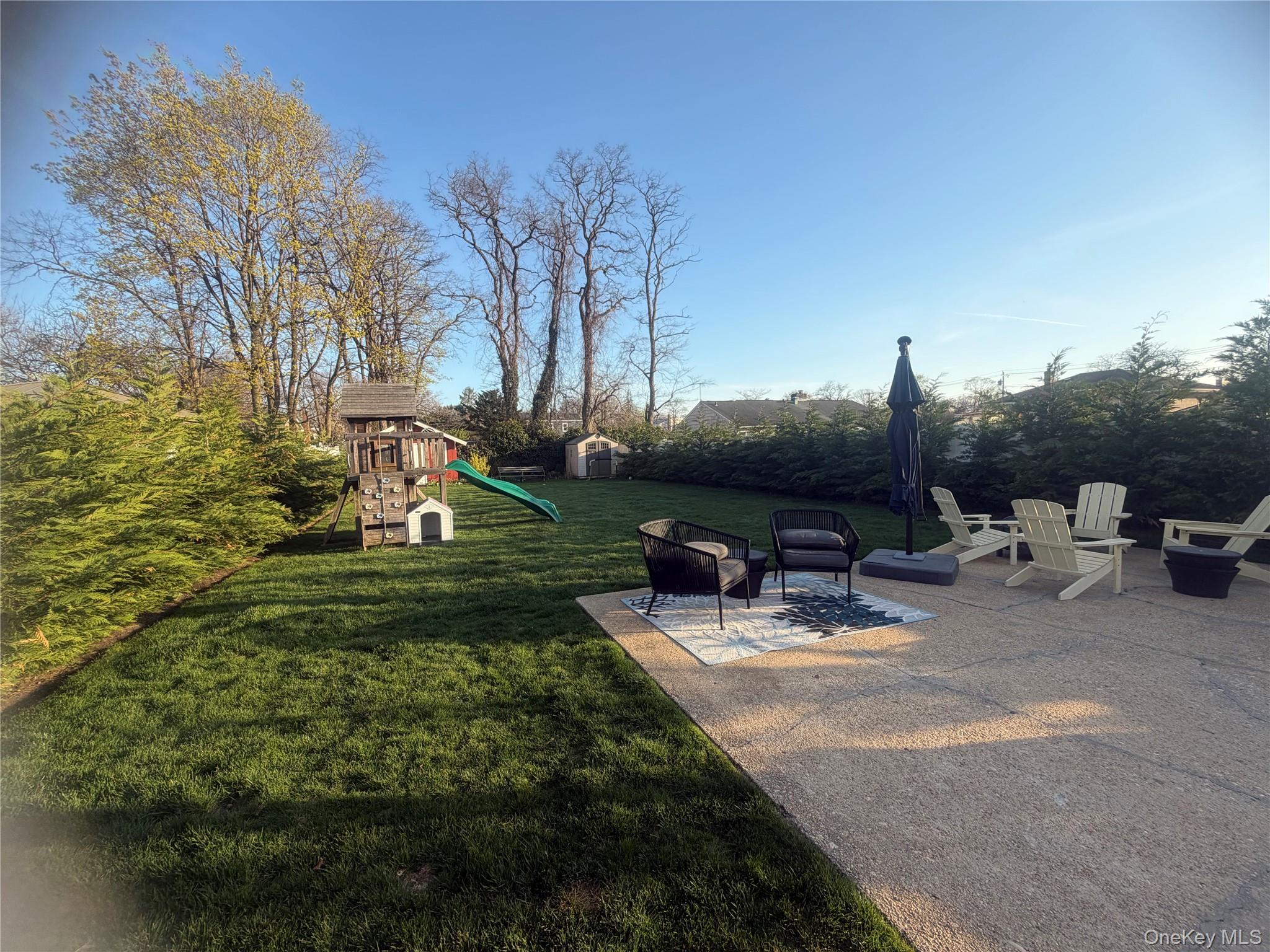 1580 North Jerusalem Road Merrick, NY 11566 - Photo 35 of 36 The property features an extensive yard with a well-maintained lawn and mature trees