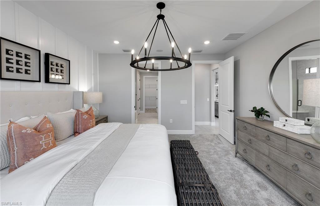 15665 Northridge Road Punta Gorda, FL 33982 - Photo 11 of 49 a bedroom with bed and a chandelier
