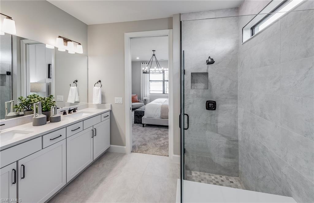 15665 Northridge Road Punta Gorda, FL 33982 - Photo 12 of 49 a spacious bathroom with a shower sink and mirror