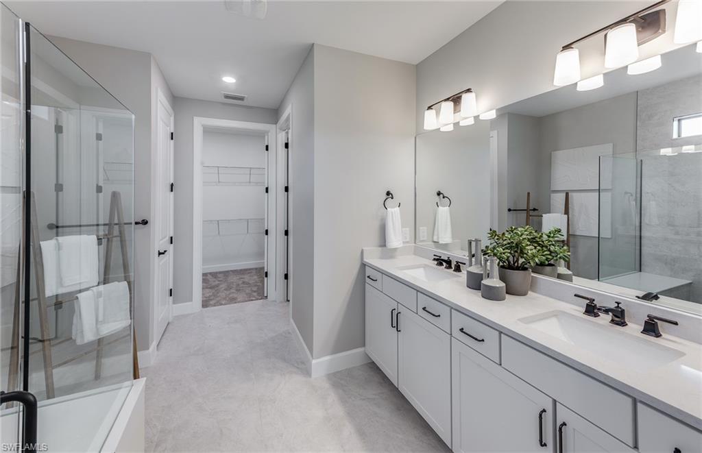 15665 Northridge Road Punta Gorda, FL 33982 - Photo 13 of 49 a spacious bathroom with a double vanity sink shower and a mirror