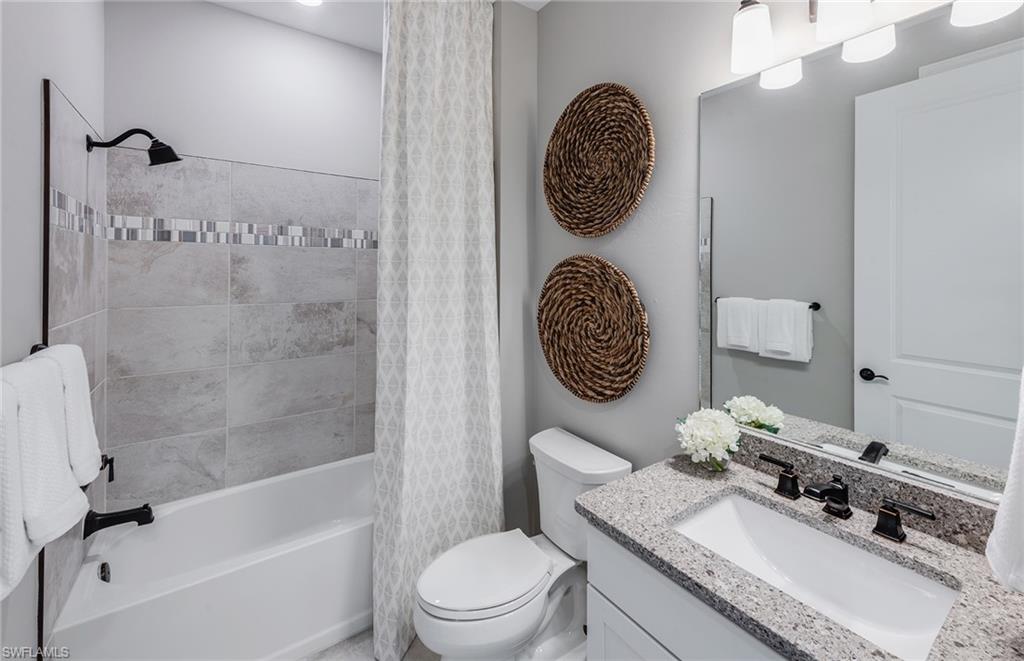 15665 Northridge Road Punta Gorda, FL 33982 - Photo 17 of 49 a bathroom with a toilet a sink and mirror