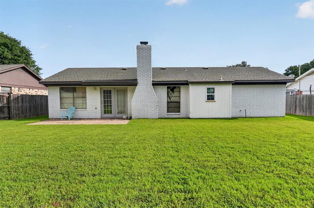 1212 Manning Road Benbrook, TX 76126 - Photo 19 of 20 Expansive rear yard featuring a large green lawn
