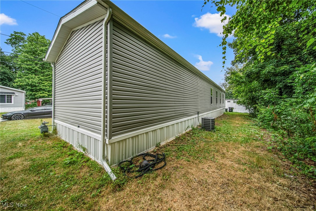 202 West Main Road, Unit LOT 13 Conneaut, OH 44030 - Photo 5 of 23 View of property exterior featuring a yard
