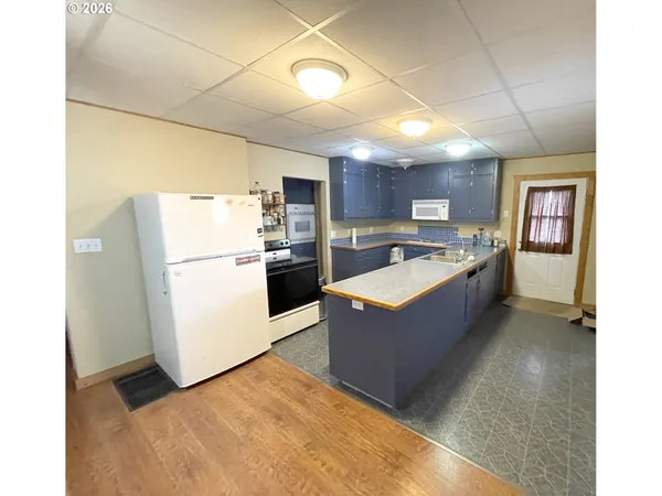 a kitchen with granite countertop a sink appliances and cabinets