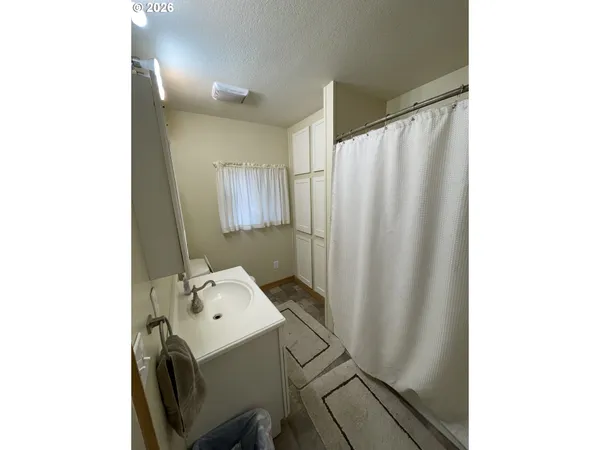 a bath room with a sink and a mirror