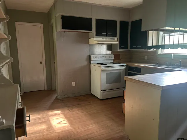 a kitchen with a stove and a microwave