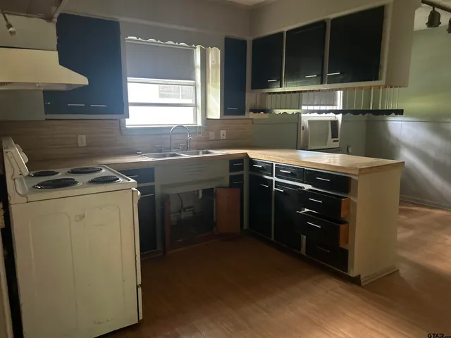 a kitchen with a stove and a sink