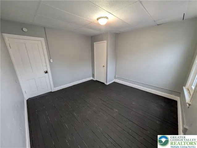 an empty room with wooden floor