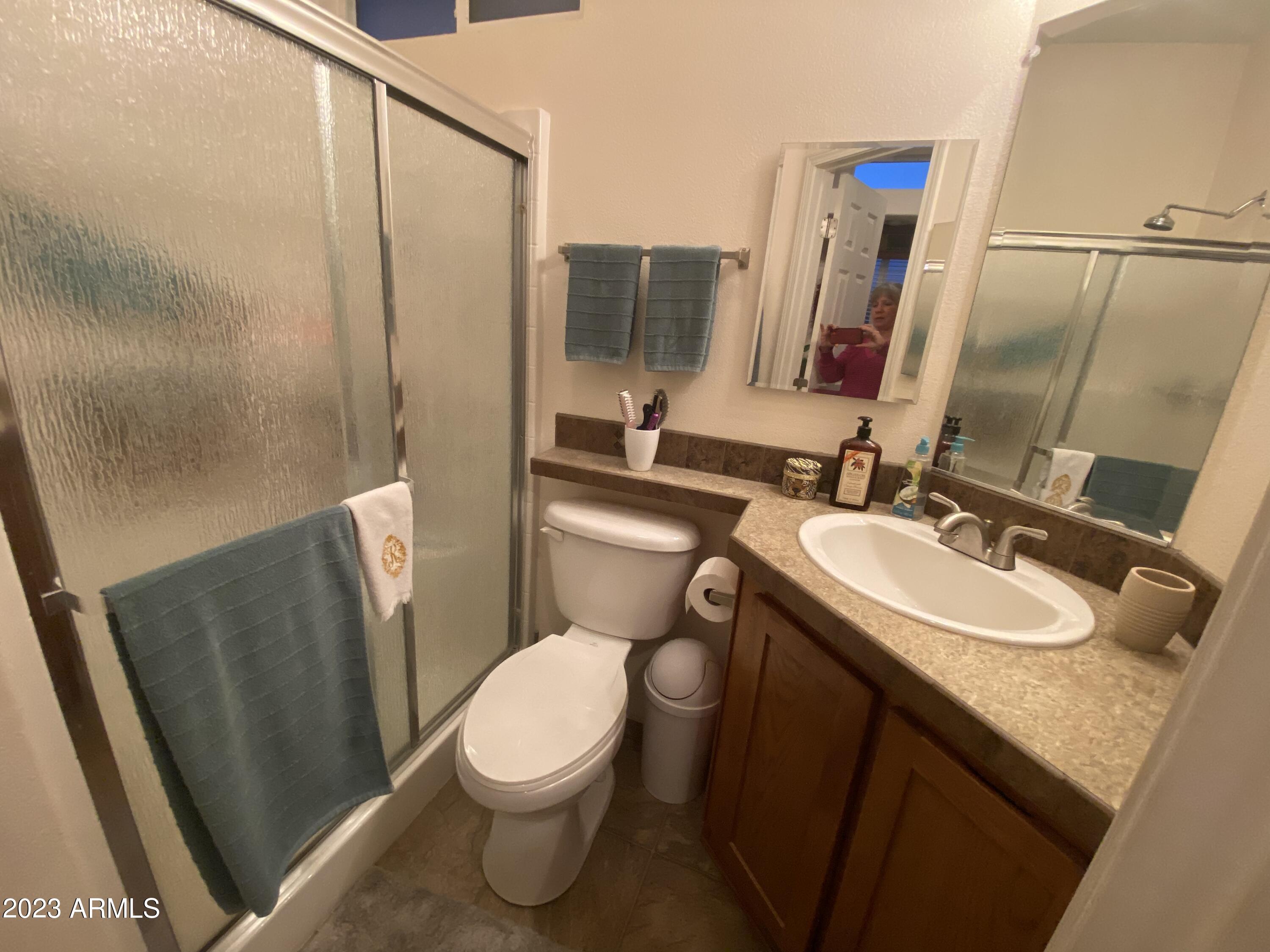 1358 Kiowa Circle, Unit 358 Apache Junction, AZ 85119 - Photo 14 of 37 a bathroom with a granite countertop sink toilet and shower