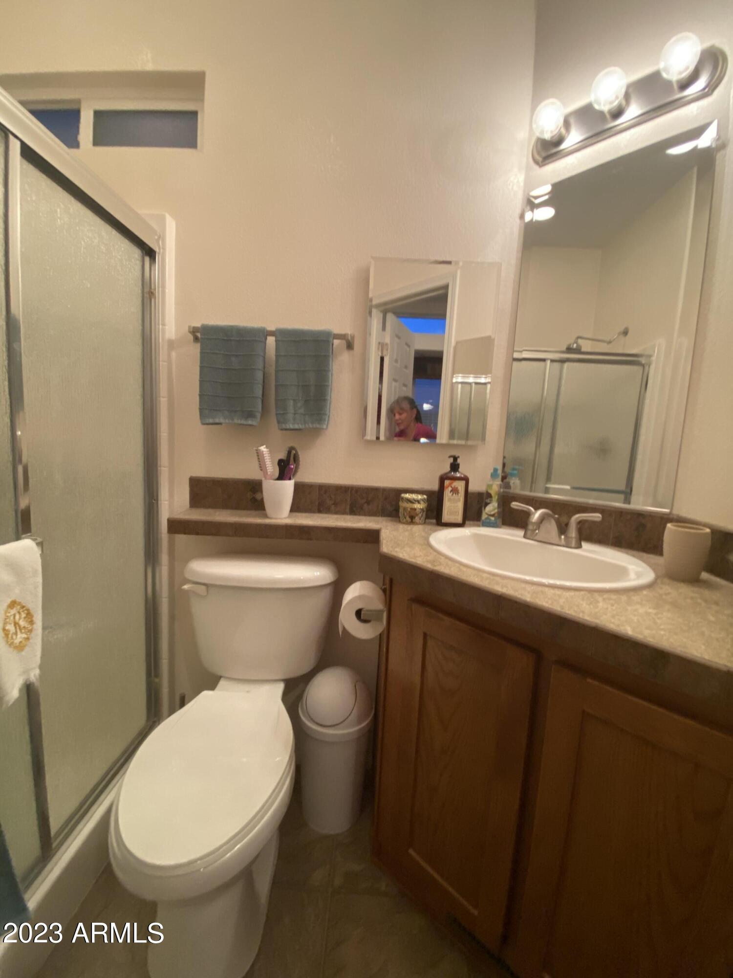 1358 Kiowa Circle, Unit 358 Apache Junction, AZ 85119 - Photo 15 of 37 a bathroom with a toilet sink and mirror