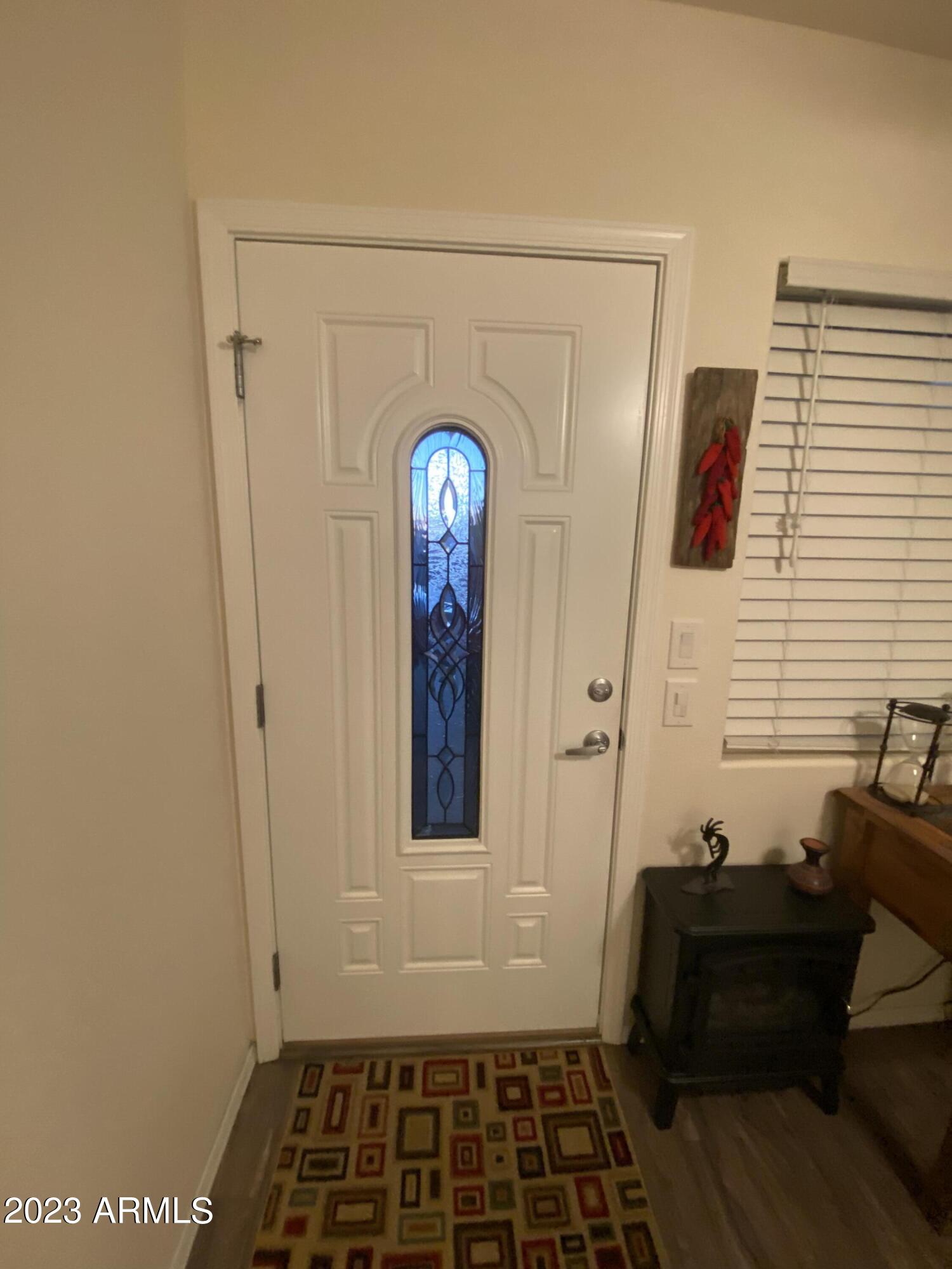 1358 Kiowa Circle, Unit 358 Apache Junction, AZ 85119 - Photo 17 of 37 a view of a hallway with wooden floor and a cabinet