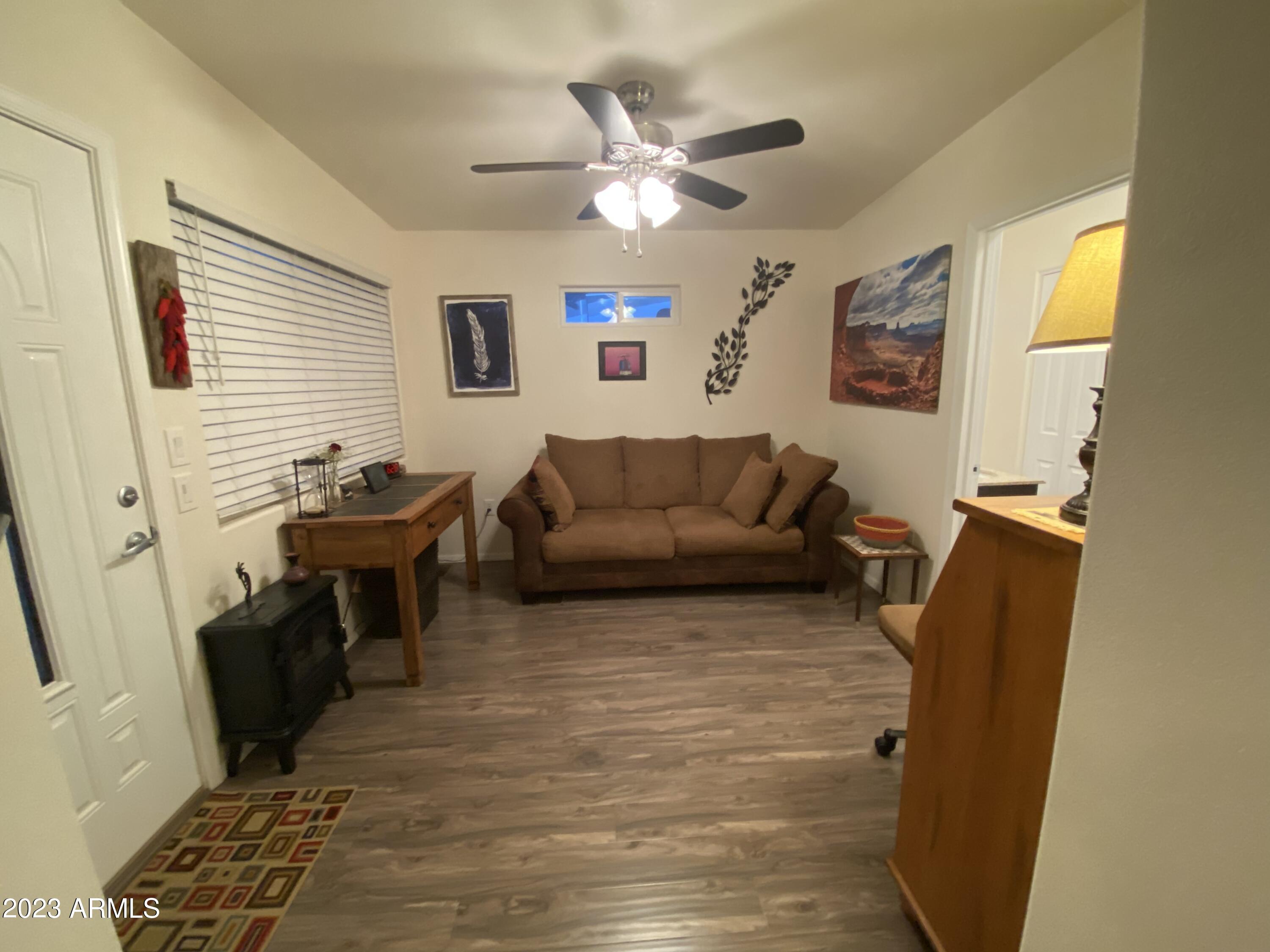 1358 Kiowa Circle, Unit 358 Apache Junction, AZ 85119 - Photo 20 of 37 a living room with furniture and a flat screen tv